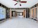 Living room renovation project showcasing exposed studs, recessed lighting, and terrazzo floors at 560 Baywood N Dr, Dunedin, FL 34698