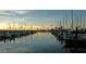 Picturesque marina at sunset, filled with sailboats and yachts reflecting on the tranquil water at 560 Baywood N Dr, Dunedin, FL 34698