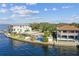 Waterfront property featuring modern home, pool, and dockside access on a sunny day at 594 Riviera Dr, Tampa, FL 33606