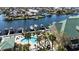 Aerial view of luxurious waterfront homes with boat docks and a community pool at 6327 Sunset Bay Cir, Apollo Beach, FL 33572