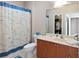 Bathroom with a toilet, walk-in closet, vanity with sink, and a shower curtain with nautical patterns at 6327 Sunset Bay Cir, Apollo Beach, FL 33572