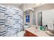 Well-lit bathroom featuring a fish-themed shower curtain, toilet, and sink at 6327 Sunset Bay Cir, Apollo Beach, FL 33572