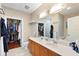 Spacious bathroom with double sinks, a large mirror and walk-in closets at 6327 Sunset Bay Cir, Apollo Beach, FL 33572