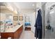 Bright bathroom featuring double sinks, a soaking tub, a walk-in shower, and a view to the bedroom at 6327 Sunset Bay Cir, Apollo Beach, FL 33572