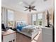 Bright bedroom featuring a ceiling fan, plush carpet, and large windows that let in plenty of natural light at 6327 Sunset Bay Cir, Apollo Beach, FL 33572