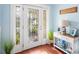 Inviting entryway with a decorative glass door, beach themed decor, and wood flooring at 6327 Sunset Bay Cir, Apollo Beach, FL 33572