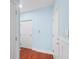 Hallway with wood floors and multiple doors to other spaces at 6327 Sunset Bay Cir, Apollo Beach, FL 33572