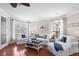 Bright living room featuring hardwood floors, stylish furniture, and large windows at 6327 Sunset Bay Cir, Apollo Beach, FL 33572
