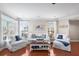 Bright living room featuring hardwood floors, stylish furniture, and large windows at 6327 Sunset Bay Cir, Apollo Beach, FL 33572