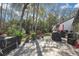 Back patio showcasing lush greenery, with a paver patio perfect for relaxing at 6395 Pinestand Ct, Spring Hill, FL 34606