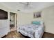 Bright bedroom features a floral comforter and wood-look floors at 6395 Pinestand Ct, Spring Hill, FL 34606