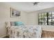 Cozy bedroom with a floral comforter and a window offering natural light at 6395 Pinestand Ct, Spring Hill, FL 34606