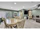 Charming dining area offers natural light, complemented by stylish furniture and wood-look flooring at 6395 Pinestand Ct, Spring Hill, FL 34606