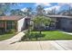 Well-maintained townhomes with stone accents, mature trees, and manicured lawns at 6395 Pinestand Ct, Spring Hill, FL 34606