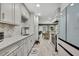 Stylish kitchen boasts a modern backsplash, sleek appliances, and seamless transition to the dining area at 6395 Pinestand Ct, Spring Hill, FL 34606