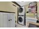 Well-organized laundry room equipped with stacked washer/dryer and modern cabinetry at 6395 Pinestand Ct, Spring Hill, FL 34606