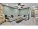 Inviting living room features a comfortable gray sofa and a decorative ceiling fan for added comfort at 6395 Pinestand Ct, Spring Hill, FL 34606