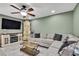 Inviting living room featuring a cozy seating arrangement, modern entertainment center, and ample natural light at 6395 Pinestand Ct, Spring Hill, FL 34606