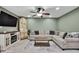 Comfortable living room includes a large sectional sofa, entertainment center, and a warm ambiance at 6395 Pinestand Ct, Spring Hill, FL 34606