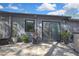 A lovely patio with pavers and a sliding glass door, with plants as decor at 6395 Pinestand Ct, Spring Hill, FL 34606