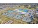 Aerial view of tennis courts, playground, and surrounding neighborhood, showcasing community amenities at 6494 Beverly Hills Dr, Zephyrhills, FL 33541
