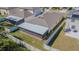 Aerial view of a screened in patio addition with a well maintained fenced in backyard and green grass at 6494 Beverly Hills Dr, Zephyrhills, FL 33541