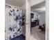 Bright bathroom area with a full shower and partial view of a bedroom space at 6494 Beverly Hills Dr, Zephyrhills, FL 33541