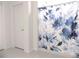 This bathroom features blue-and-white floral-patterned shower curtain at 6494 Beverly Hills Dr, Zephyrhills, FL 33541