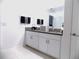 This modern bathroom features a double sink vanity with granite countertops at 6494 Beverly Hills Dr, Zephyrhills, FL 33541