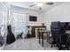 Bedroom space with a ceiling fan, desk, guitar, television, and cat tree at 6494 Beverly Hills Dr, Zephyrhills, FL 33541
