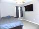 Bedroom featuring a comfortable bed, window with dark curtains, and carpet at 6494 Beverly Hills Dr, Zephyrhills, FL 33541