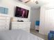 This bedroom features a television, ceiling fan, and dual closets for plenty of storage at 6494 Beverly Hills Dr, Zephyrhills, FL 33541