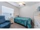 Bright bedroom with a daybed, armchair, nightstand, ceiling fan, and a window at 6494 Beverly Hills Dr, Zephyrhills, FL 33541