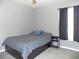 Bedroom featuring a comfortable bed with drawers, a window with dark curtains, and carpet at 6494 Beverly Hills Dr, Zephyrhills, FL 33541