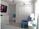 Bedroom showcases a neutral color scheme, and modern entertainment with a wall-mounted television and ample storage at 6494 Beverly Hills Dr, Zephyrhills, FL 33541