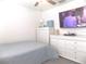 This bedroom features a television, ceiling fan, and white dresser and drawers at 6494 Beverly Hills Dr, Zephyrhills, FL 33541