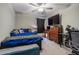Bedroom space with a ceiling fan, bed, television, and desk area at 6494 Beverly Hills Dr, Zephyrhills, FL 33541
