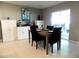 Cozy dining room with a modern table and chairs, leading to the patio at 6494 Beverly Hills Dr, Zephyrhills, FL 33541