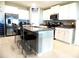 Spacious kitchen featuring stainless steel appliances, granite countertops, and a breakfast bar at 6494 Beverly Hills Dr, Zephyrhills, FL 33541
