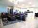 Open-concept living room with sofas, ceiling fan, and tiled floors at 6494 Beverly Hills Dr, Zephyrhills, FL 33541
