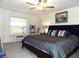Comfortable bedroom with a ceiling fan, decorative pillows, and a serene atmosphere at 6494 Beverly Hills Dr, Zephyrhills, FL 33541