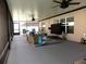 Spacious screened patio featuring multiple ceiling fans, ample seating, and durable flooring at 6494 Beverly Hills Dr, Zephyrhills, FL 33541