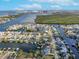 A waterfront neighborhood seen from above on a sunny day, with homes having private docks and waterway access at 6606 Dolphin Cove Dr, Apollo Beach, FL 33572