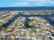 An aerial view of waterfront homes with private docks and stunning ocean view on a sunny day in a desirable neighborhood at 6606 Dolphin Cove Dr, Apollo Beach, FL 33572