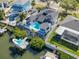 Stunning aerial view of waterfront property with pool, private dock, boat lift, and fenced backyard at 6606 Dolphin Cove Dr, Apollo Beach, FL 33572
