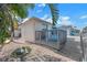 Backyard shows deck, walkway, lush greenery, and inviting outdoor spaces, blending nature and leisure at 6606 Dolphin Cove Dr, Apollo Beach, FL 33572