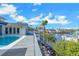 Waterfront view from the deck shows the pool, backyard, and dock, perfect for waterfront living at 6606 Dolphin Cove Dr, Apollo Beach, FL 33572