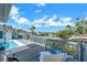 Waterfront view from deck with chairs, grill and railing looks to the waterway at 6606 Dolphin Cove Dr, Apollo Beach, FL 33572