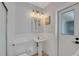 Bathroom featuring a pedestal sink, and a brightly lit mirror at 6606 Dolphin Cove Dr, Apollo Beach, FL 33572