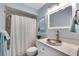 Powder blue bathroom with white vanity, modern fixtures, and shower/tub combination at 6606 Dolphin Cove Dr, Apollo Beach, FL 33572